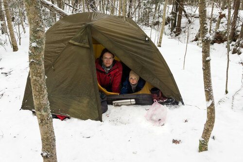 in a tent with a child in winter