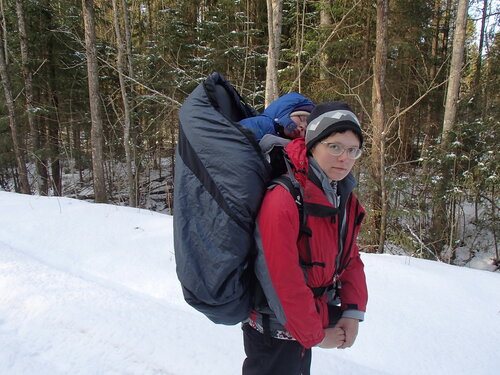 winter hiking through the forest with a child in Deuter kid comfort 3